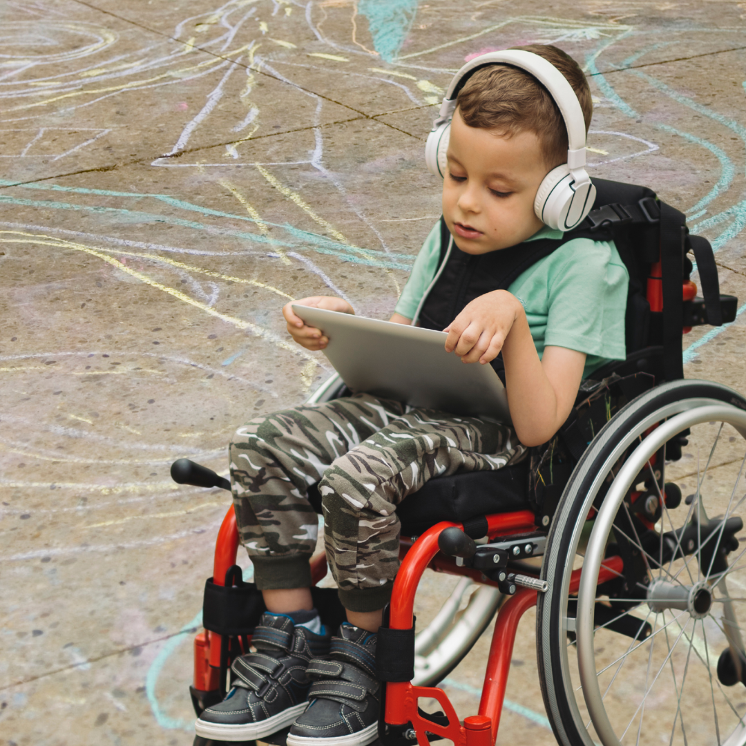 Child with headphones in wheelchair