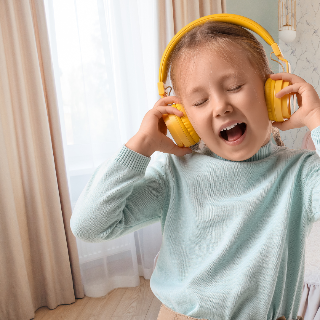 Girl ins pastel shirt listening to podcast with headphones